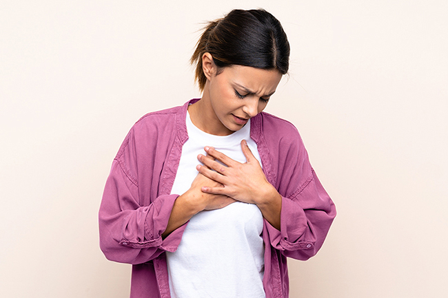 Woman,Over,Isolated,Background,Having,A,Pain,In,The,Heart